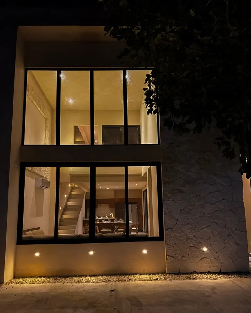 Villa Corax facade at night: two levels with lit-up windows
